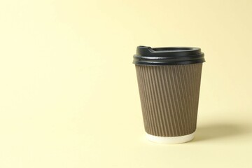 Paper cup with plastic lid on light background. Coffee to go