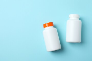 White bottles on blue background, top view