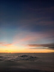 Fototapeta premium The majestic charm of a mountain towering above a sea of clouds, bathed in golden sunlight that radiates magical beauty.