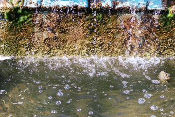 A beautiful waterfall with bubbles continuously bubbling out of it
