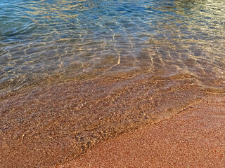 Gentle waves of sea on sand beach.