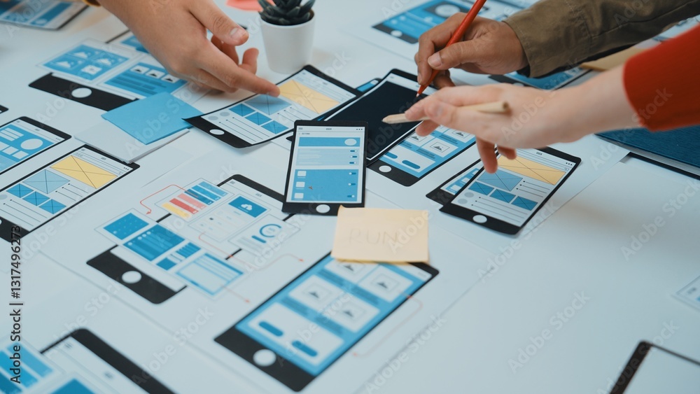 Poster a dynamic workspace showcasing a collaborative app design process, featuring hands engaged with sket
