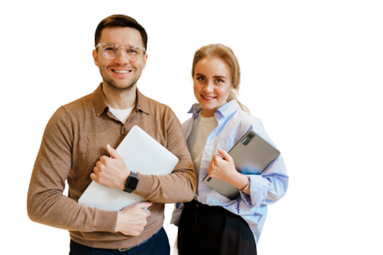 Young professionals holding laptops are smiling and posing on a plain background in a business setting