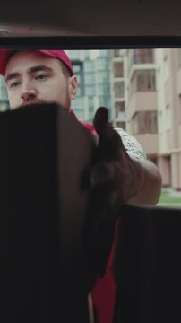 courier African American open car gives a parce to a man after signing on delivery device cardboard technology box order post postal service device sunny beard covered load logistic mailman