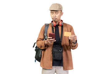 Young Indonesian male traveler traveling with credit card, convenience of cashless transaction, travel concept, isolated on white background.