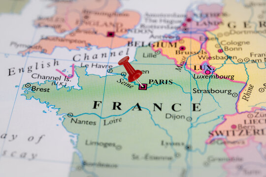 Colorful tourist location map with red stick pin at  Paris, France, and the surrounding countries