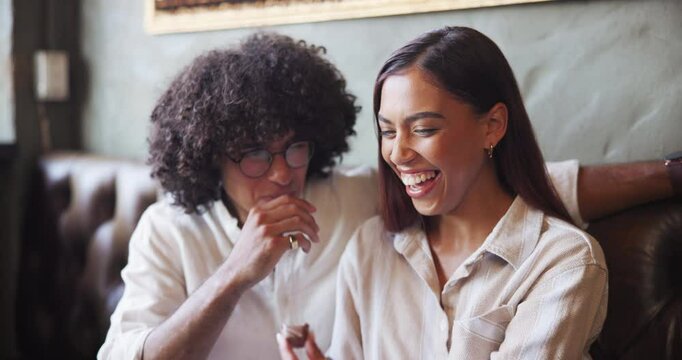 Smile, love and feeding couple chocolate in cafe for romance, dessert and laugh together. Man, woman and eating sweets on date in restaurant for valentines day celebration, talk or happy with treats
