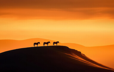 Fototapeta premium Majestic horses silhouetted against stunning sunset landscape