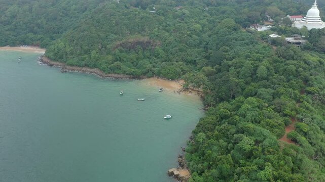 Aerial view of tropical Jungle Beach in Unawatuna Sri Lanka. Panoramic view of exotic coastline and tropical forest. Paradise Beach.