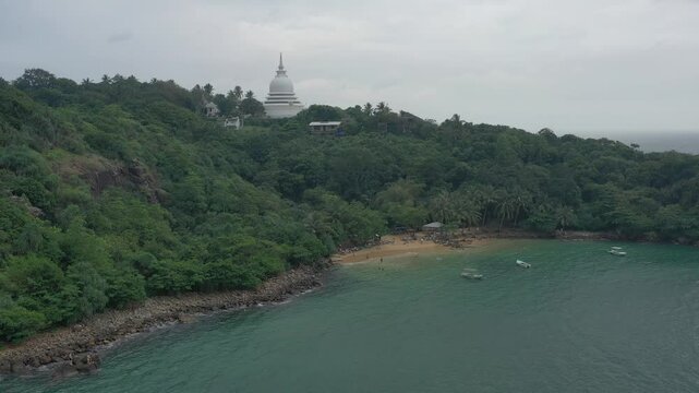 Aerial view of tropical Jungle Beach in Unawatuna Sri Lanka. Panoramic view of exotic coastline and tropical forest. Paradise Beach.