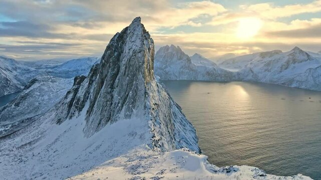 flight over snowy Segla summit at Mefjord on Senja Island
