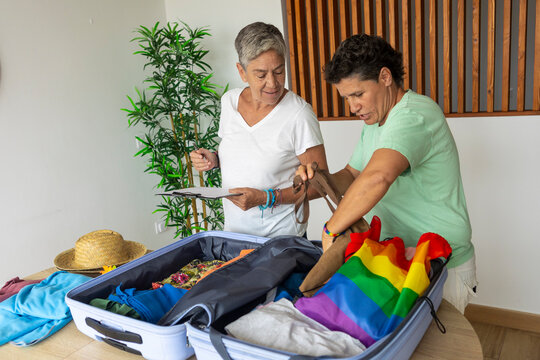 mature lesbian couple packing for a summer vacation
