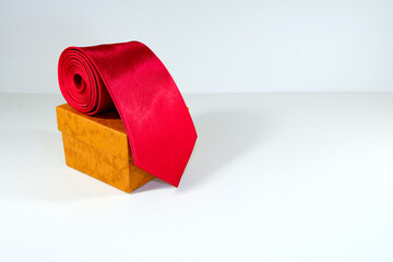 plain red tie rolled with gift box closeup view