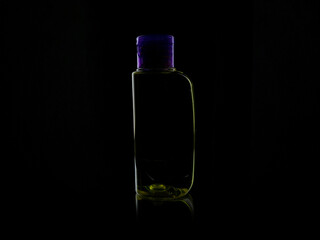 small plastic bottle on black