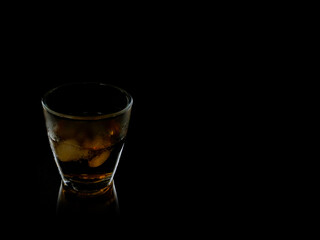 glass of whiskey on black background