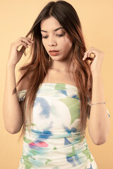 Elegant Young Woman in White Floral Summer Dress Posing Against White Background
