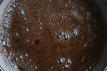 Bubbles on coffee. Surface of brewed coffee with bubbles. Brewed coffee.