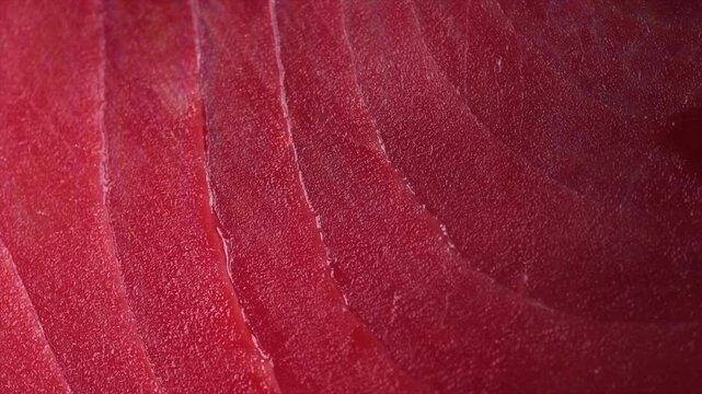 Tuna texture background, steak. Fresh raw tuna fish fillet close-up, sea fish rotating backdrop, top view, flat lay. Fresh sliced bluefin tuna raw meat texture macro shot.