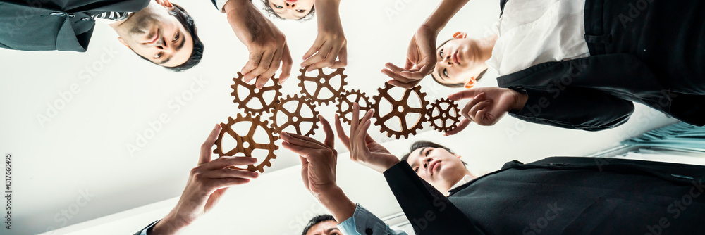 Poster below view group of multiracial business people joining gear wheels together as effective unity and 
