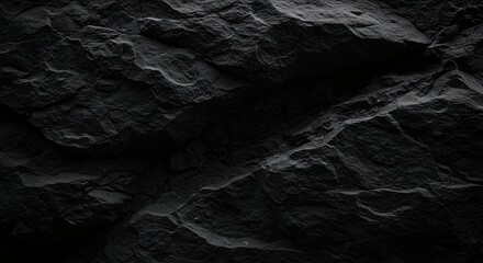 Fototapeta premium Black abstract background. Grunge background with copy space. The surface of the mountain close-up. Dark gray stone background. Rock texture.