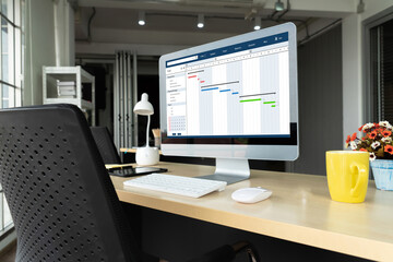 Project planning software for modish business project management on the computer screen showing timeline chart of the team project