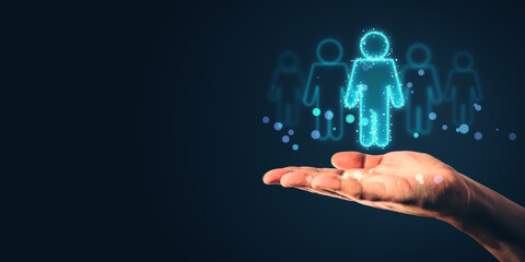 Hand holding hologram of human figure on dark background.