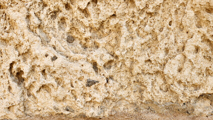 Texture of a ancient hand carved wall stone as a natural backgorund for design works 