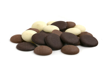 multicolored chocolate drops on white background