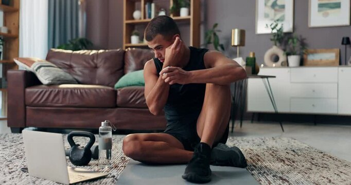 Laptop, fitness and music with man in living room for streaming workout class, learning and health. Exercise, wellness and training with person and home gym for sports, virtual course and earphones