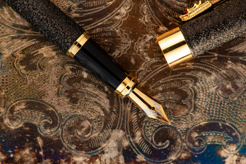 Fountain pen, beautiful fountain pen on an old metal surface with beautiful embossed ornaments,...