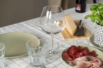 close up woman hands Pouring white wine or Prosecco into a glass from a bottle for an aperitif