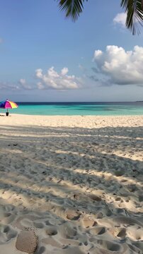 Plage tropicale avec parasol color&eacute; et mer turquoise