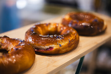 Freshly baked bagel with cherries in a bakery on a display window.