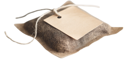 A tea bag with a tag and string slightly lifted on a white background --ar 16:9