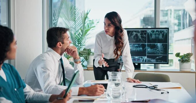 Woman, doctors and meeting with x ray, monitor and review for diagnosis, team or planning surgery at clinic. Person, presentation and screen with bones, spine injury or analysis in hospital boardroom