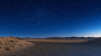 Starry Night over Desert Landscape: A Serene Nighttime View of Star-Filled Sky Above Expansive Desert Plains
