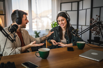 two young adult hosts record together podcast in home studio