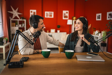 two young adult hosts record together podcast in home studio