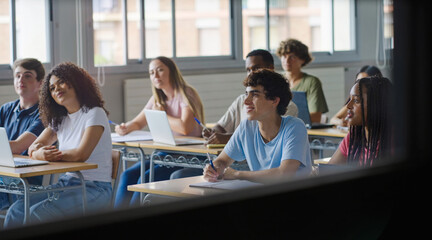 Group of teenager students listening to professor lecture at college school classroom