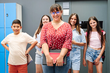 Young female teacher with a group of primary school students together at School