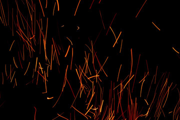 sparks from the fire glowing in the dark
