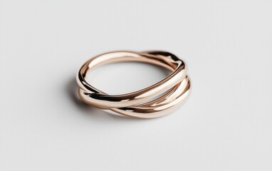 Fototapeta premium Rose Gold Intertwined Ring on White Background