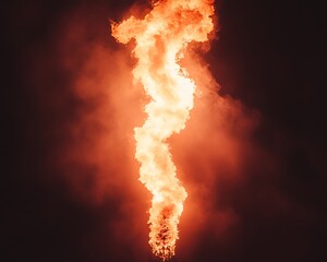 A tall column of intense fire erupts with billowing smoke