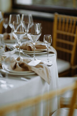 A beautifully arranged table with wine glasses and neatly folded napkins, perfect for a sophisticated dining event.