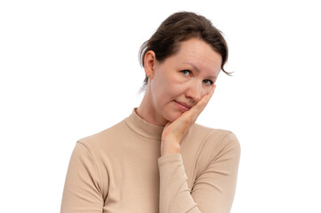A woman with a neutral expression resting her chin on her hand against a white background.