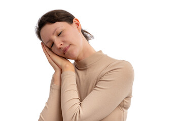 A young woman in a beige turtleneck gently resting her head on her hands, expressing calmness.