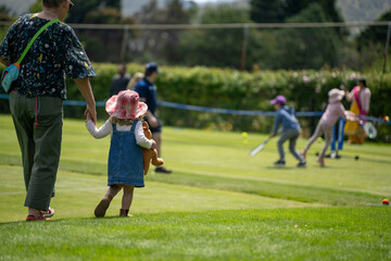 children play grass tennis in a lawn tennis court learning and having fun