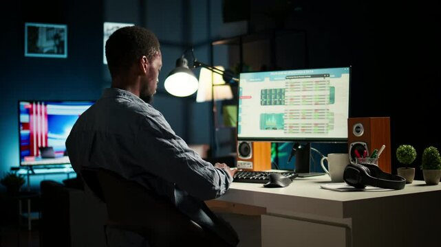 African american investment expert working from home analyzing financial statistics, developing a global investment solution for growth. Economy advisor examines declared revenue. Camera A.