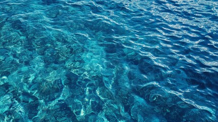 Fototapeta premium Sunlight streaming through the surface of the blue ocean, illuminating the sea waves and the clear waters below during the summer.