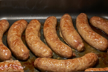 Sausages with cheese, baked in the oven. Close-up.